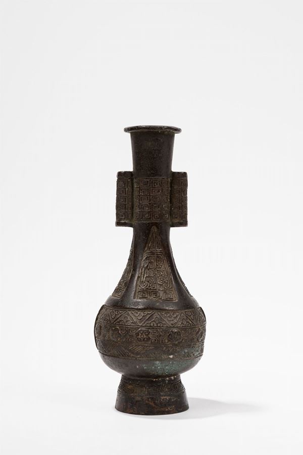 A SMALL BRONZE ARROW VASE