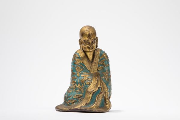 A GILT AND ENAMEL COPPER FIGURE